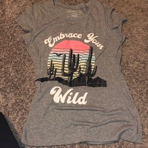 Grey T-shirt with embrace your wild wording and cactus setting.